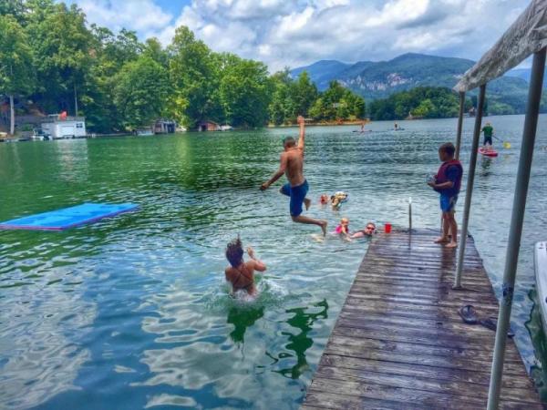 kids jumping off dock into the lake