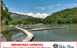 Marina on a sunny day with text Important Updates Temporary Lake Lowering for Repairs