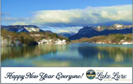 Lake and hills with text under that reads Happy New Year Everyone! Lake Lure