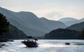 Boat on Lake Lure with Skier - Reminder to get your 2023 Boat Permit