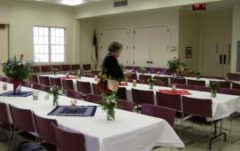 Rectangular tables with chairs inside community hall