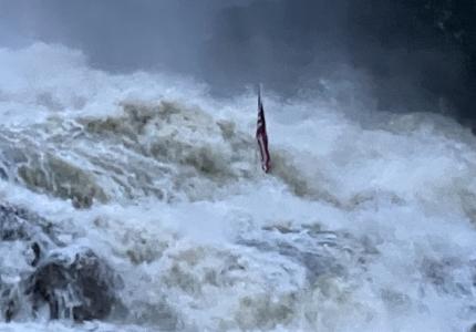 Hurricane Helene behind the Dam with American Flag