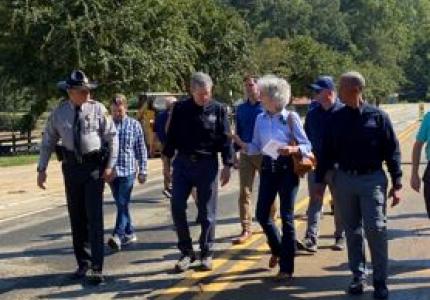 Mayor Pritchett with Gov Cooper and others touring Lake Lure