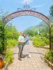 Couple under Flowering Bridge Arched Sign