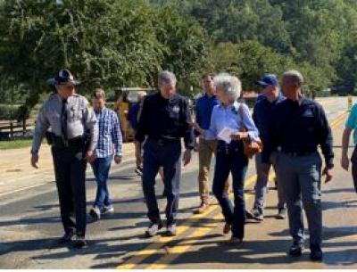 Mayor Pritchett with Gov Cooper and others touring Lake Lure