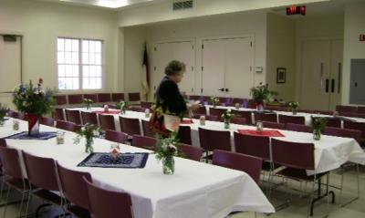 Rectangular tables with chairs inside community hall